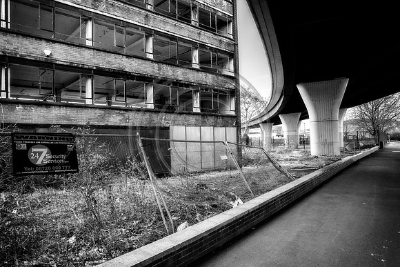 Derelict office building under motorway flyover